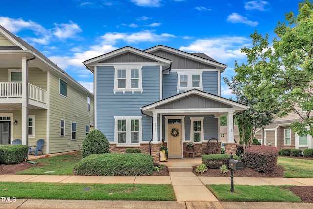 533 Duchart Ln, Fuquay Varina, NC 27526 - view of front of home with board and batten siding, a porch, and stone siding