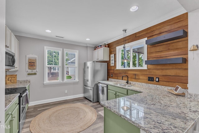 533 Duchart Ln, Fuquay Varina, NC 27526 - kitchen featuring green cabinetry, appliances with stainless steel finishes, a sink, healthy amount of natural light, and crown molding