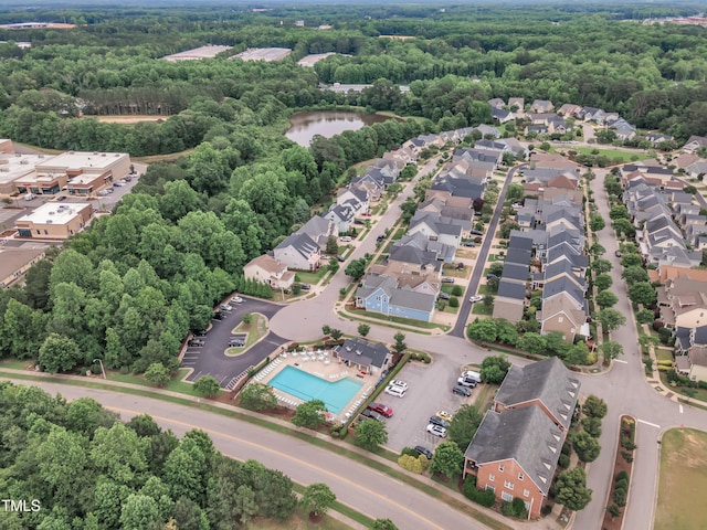 533 Duchart Ln, Fuquay Varina, NC 27526 - aerial view of property and surrounding area featuring nearby suburban area, a pool area, and a heavily wooded area