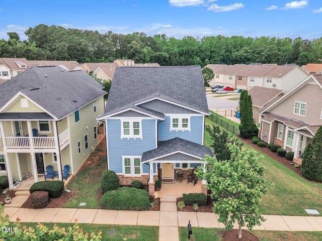 533 Duchart Ln, Fuquay Varina, NC 27526 - view of front facade with a residential view, covered porch, board and batten siding, roof with shingles, and a patio area