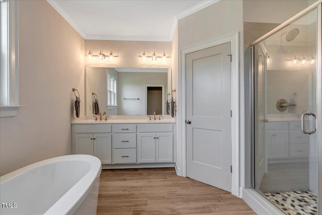 1779 Walter Grissom Rd, Kittrell, NC 27544 - bathroom featuring double vanity, a freestanding tub, a stall shower, crown molding, and wood finished floors