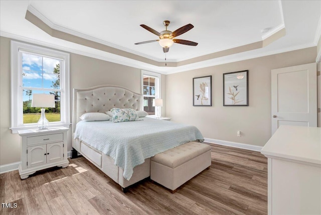 1779 Walter Grissom Rd, Kittrell, NC 27544 - bedroom featuring a tray ceiling, ornamental molding, light wood-type flooring, baseboards, and a ceiling fan