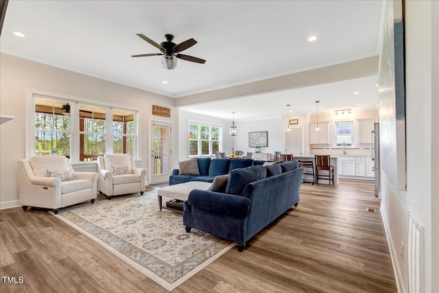 1779 Walter Grissom Rd, Kittrell, NC 27544 - living area featuring wood finished floors, crown molding, a ceiling fan, recessed lighting, and baseboards