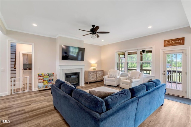1779 Walter Grissom Rd, Kittrell, NC 27544 - living area with light wood-type flooring, a tile fireplace, crown molding, a ceiling fan, and recessed lighting