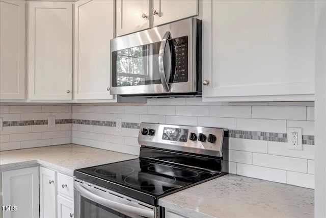 1779 Walter Grissom Rd, Kittrell, NC 27544 - kitchen with appliances with stainless steel finishes, white cabinets, and backsplash