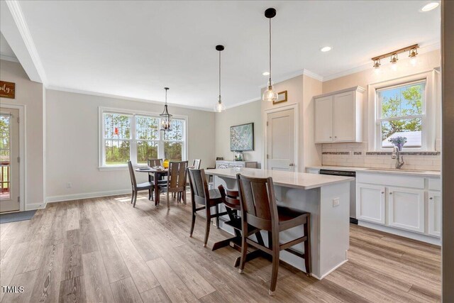 1779 Walter Grissom Rd, Kittrell, NC 27544 - kitchen featuring dishwashing machine, crown molding, light countertops, a kitchen island, and a sink