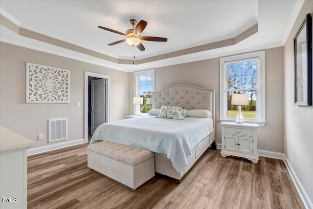1779 Walter Grissom Rd, Kittrell, NC 27544 - bedroom with a tray ceiling, ornamental molding, wood finished floors, and baseboards