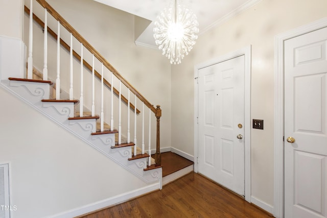 102 W Hill Dr, Cary, NC 27519 - foyer entrance with a chandelier, wood finished floors, crown molding, stairway, and baseboards