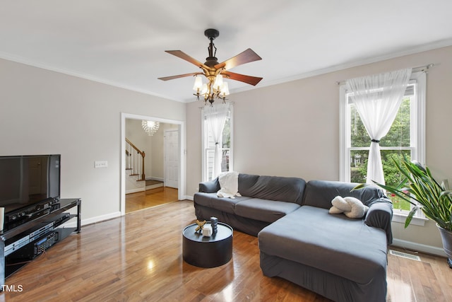 102 W Hill Dr, Cary, NC 27519 - living room featuring stairs, healthy amount of natural light, ceiling fan, crown molding, and wood finished floors