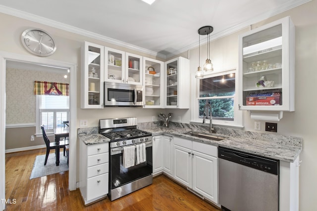 102 W Hill Dr, Cary, NC 27519 - kitchen featuring stainless steel appliances, a sink, white cabinetry, light stone countertops, and crown molding