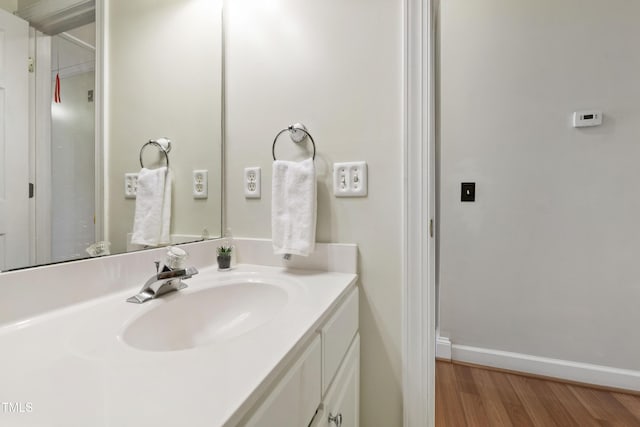 102 W Hill Dr, Cary, NC 27519 - bathroom featuring vanity, wood finished floors, and baseboards