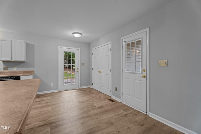 627 Gaslight Trl, Wendell, NC 27591 - unfurnished dining area featuring light wood-style floors and baseboards