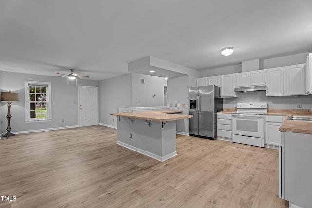 627 Gaslight Trl, Wendell, NC 27591 - kitchen featuring white electric stove, stainless steel fridge, under cabinet range hood, light wood finished floors, and a ceiling fan