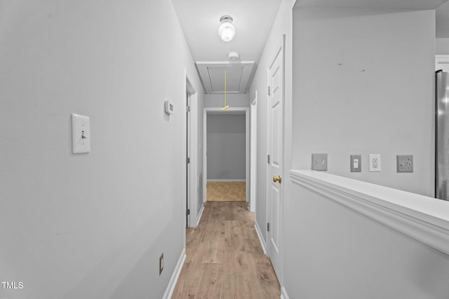 627 Gaslight Trl, Wendell, NC 27591 - corridor featuring attic access, light wood-type flooring, and baseboards