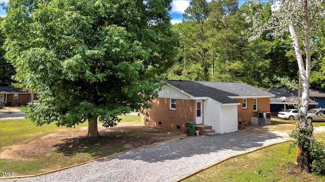 101 Apollo Cir, Roanoke Rapids, NC 27870 - view of home's exterior featuring brick siding, gravel driveway, crawl space, and a shingled roof