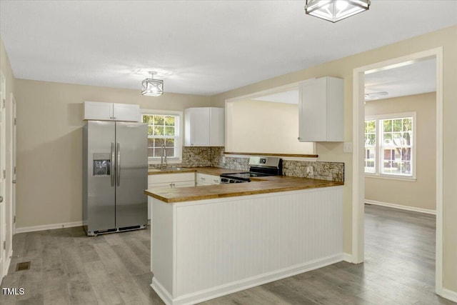 101 Apollo Cir, Roanoke Rapids, NC 27870 - kitchen with stainless steel appliances, light wood finished floors, tasteful backsplash, and healthy amount of natural light