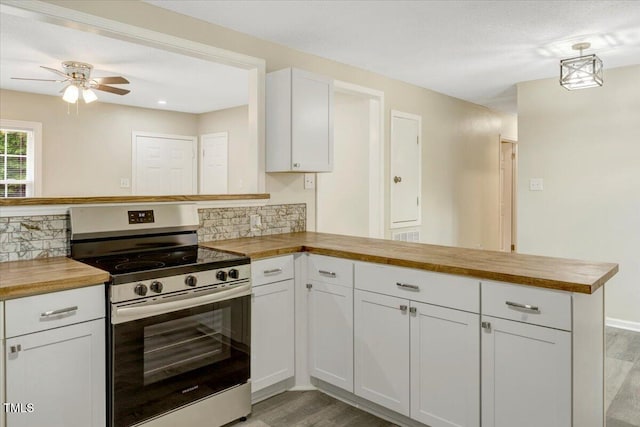 101 Apollo Cir, Roanoke Rapids, NC 27870 - kitchen with electric range, wood counters, a peninsula, and backsplash
