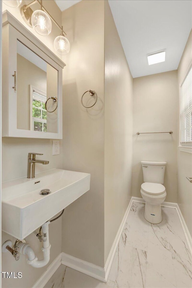 101 Apollo Cir, Roanoke Rapids, NC 27870 - half bathroom featuring toilet, marble finish flooring, and baseboards