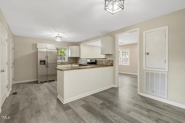 101 Apollo Cir, Roanoke Rapids, NC 27870 - kitchen with stainless steel appliances, wood finished floors, white cabinets, and healthy amount of natural light