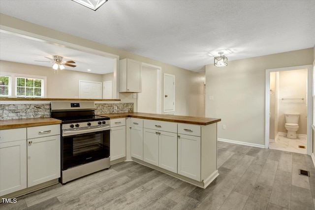 101 Apollo Cir, Roanoke Rapids, NC 27870 - kitchen with stainless steel range with electric stovetop, wood counters, light wood-type flooring, and a textured ceiling