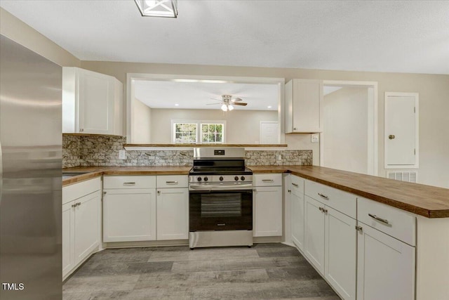 101 Apollo Cir, Roanoke Rapids, NC 27870 - kitchen featuring stainless steel appliances, butcher block countertops, a peninsula, ceiling fan, and decorative backsplash