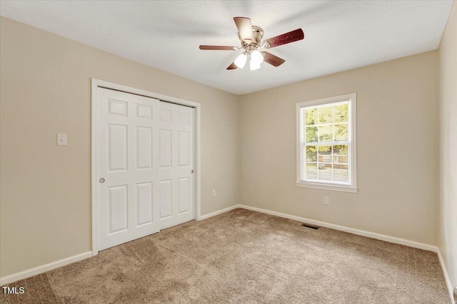 101 Apollo Cir, Roanoke Rapids, NC 27870 - unfurnished bedroom with carpet floors, a closet, baseboards, and a ceiling fan