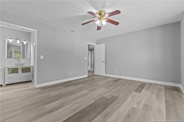 7441 Beaver Run Dr, Fayetteville, NC 28314 - unfurnished bedroom featuring light wood-type flooring, a textured ceiling, baseboards, and ceiling fan
