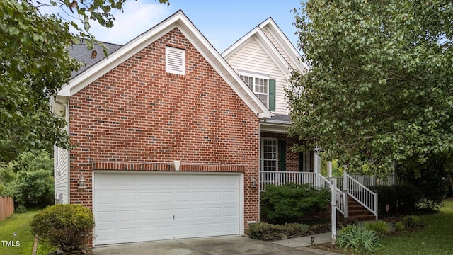 1604 Carnation Dr, Durham, NC 27703 - view of front facade with brick siding, covered porch, driveway, and a shingled roof