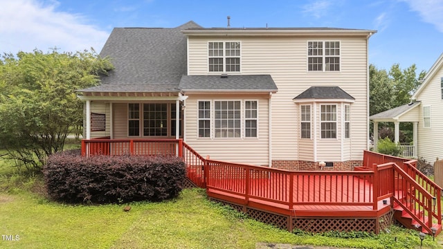 1604 Carnation Dr, Durham, NC 27703 - back of property with a lawn, a deck, and a shingled roof
