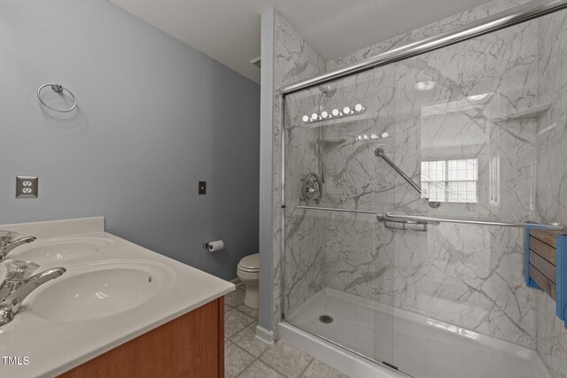 1604 Carnation Dr, Durham, NC 27703 - full bathroom with a marble finish shower, double vanity, tile patterned flooring, and toilet