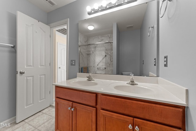 1604 Carnation Dr, Durham, NC 27703 - full bathroom featuring double vanity, a marble finish shower, tile patterned flooring, and toilet