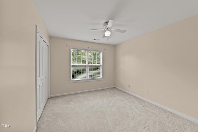 1604 Carnation Dr, Durham, NC 27703 - unfurnished bedroom featuring carpet, baseboards, a closet, and ceiling fan