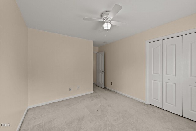 1604 Carnation Dr, Durham, NC 27703 - unfurnished bedroom featuring light colored carpet, baseboards, a closet, and ceiling fan