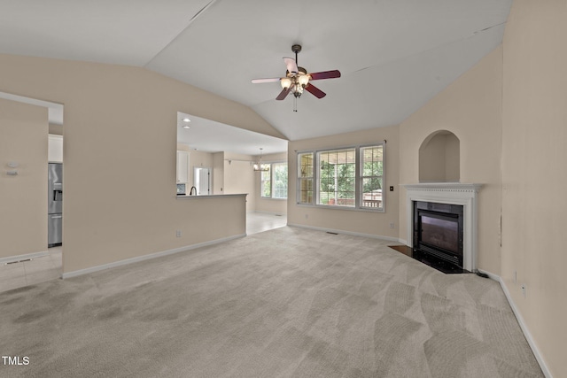 1604 Carnation Dr, Durham, NC 27703 - unfurnished living room featuring vaulted ceiling, a ceiling fan, a high end fireplace, light colored carpet, and baseboards