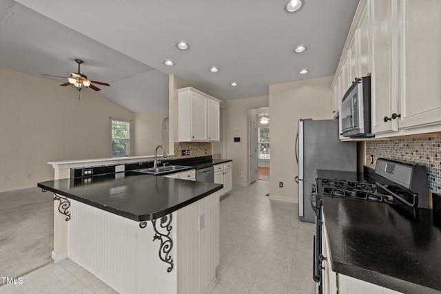 1604 Carnation Dr, Durham, NC 27703 - kitchen featuring appliances with stainless steel finishes, a sink, a peninsula, tasteful backsplash, and ceiling fan