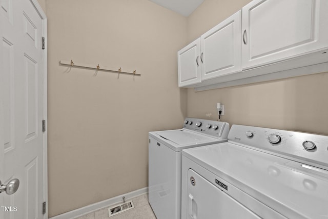 1604 Carnation Dr, Durham, NC 27703 - laundry room featuring cabinet space, separate washer and dryer, tile patterned floors, and baseboards