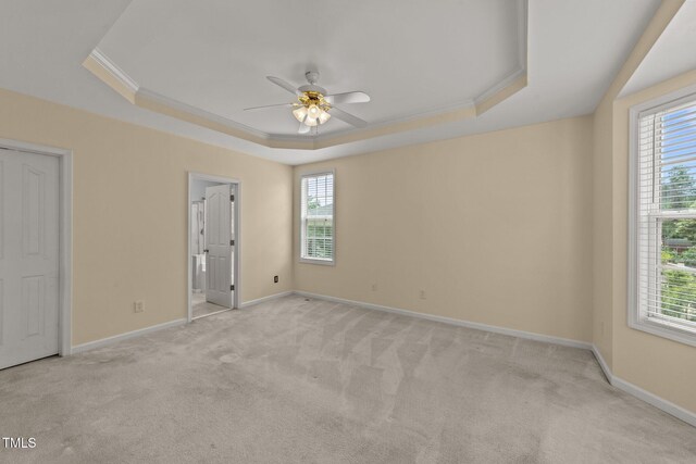 1604 Carnation Dr, Durham, NC 27703 - unfurnished bedroom featuring a raised ceiling, light carpet, baseboards, crown molding, and connected bathroom