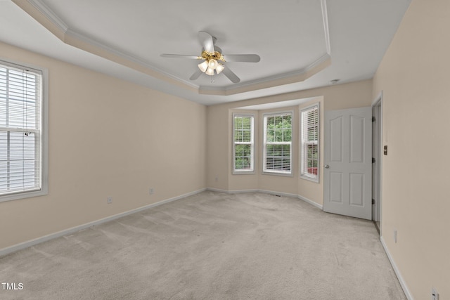 1604 Carnation Dr, Durham, NC 27703 - spare room with a tray ceiling, light colored carpet, ornamental molding, baseboards, and a ceiling fan
