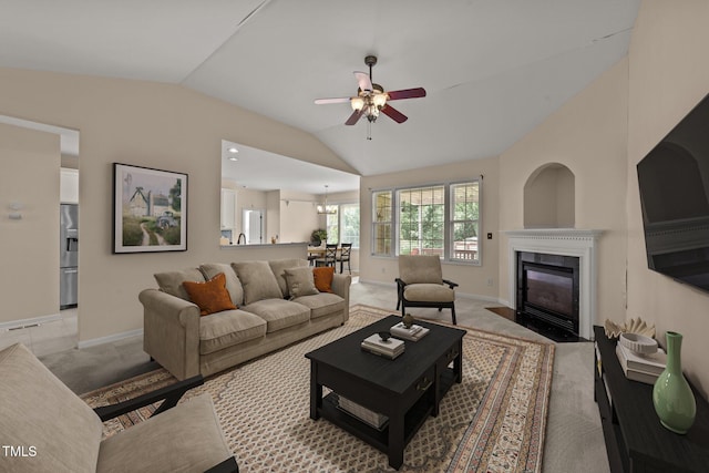1604 Carnation Dr, Durham, NC 27703 - living area featuring vaulted ceiling, ceiling fan, baseboards, a fireplace with flush hearth, and light carpet