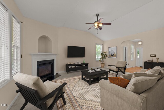 1604 Carnation Dr, Durham, NC 27703 - living room with a fireplace with flush hearth, baseboards, a ceiling fan, lofted ceiling, and light colored carpet