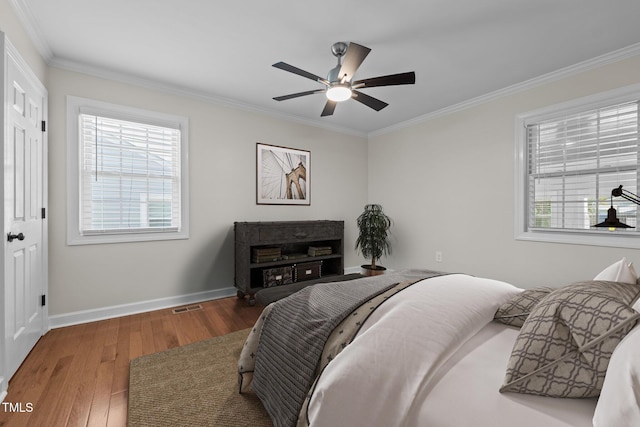 301 Williamson St, Burlington, NC 27215 - bedroom featuring wood finished floors, crown molding, multiple windows, and ceiling fan