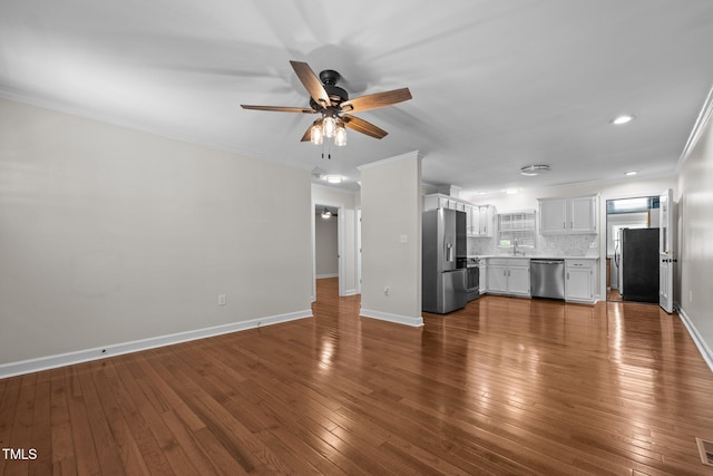 301 Williamson St, Burlington, NC 27215 - unfurnished living room featuring a ceiling fan, dark wood-type flooring, ornamental molding, and recessed lighting