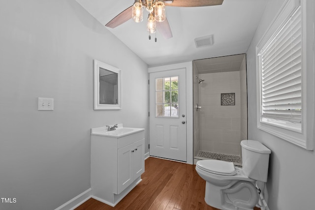 301 Williamson St, Burlington, NC 27215 - bathroom featuring a ceiling fan, vanity, a tile shower, wood finished floors, and vaulted ceiling