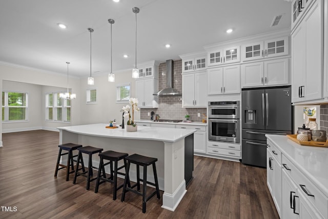 3053 Roy Ct, Apex, NC 27523 - kitchen with wall chimney exhaust hood, appliances with stainless steel finishes, a chandelier, dark wood-type flooring, and ornamental molding