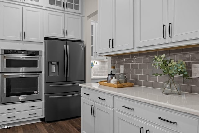 3053 Roy Ct, Apex, NC 27523 - kitchen with stainless steel appliances, light countertops, white cabinets, and tasteful backsplash