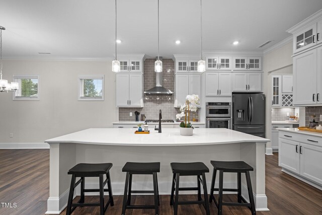3053 Roy Ct, Apex, NC 27523 - kitchen with appliances with stainless steel finishes, wall chimney range hood, decorative backsplash, light countertops, and a breakfast bar