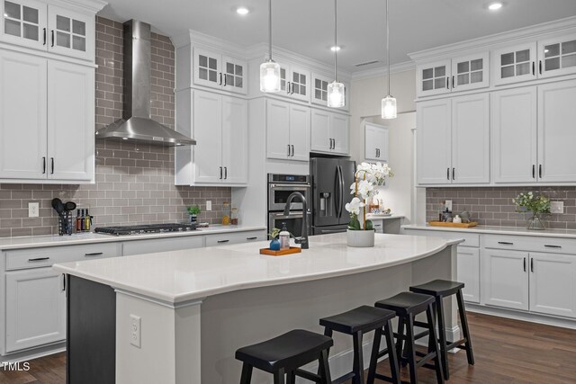 3053 Roy Ct, Apex, NC 27523 - kitchen featuring wall chimney exhaust hood, appliances with stainless steel finishes, tasteful backsplash, dark wood-type flooring, and light countertops