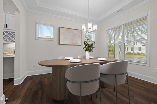 3053 Roy Ct, Apex, NC 27523 - dining area featuring healthy amount of natural light, a chandelier, dark wood-style flooring, and crown molding