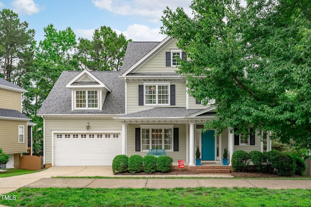 1004 Manderston Ln, Apex, NC 27502 - view of front of home with driveway, roof with shingles, a porch, and an attached garage