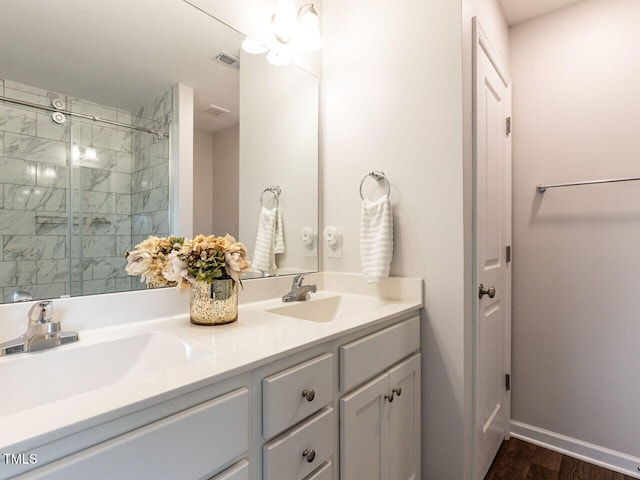 286 Beaver Tavern Dr, Benson, NC 27504 - bathroom featuring double vanity, baseboards, wood finished floors, and a tile shower
